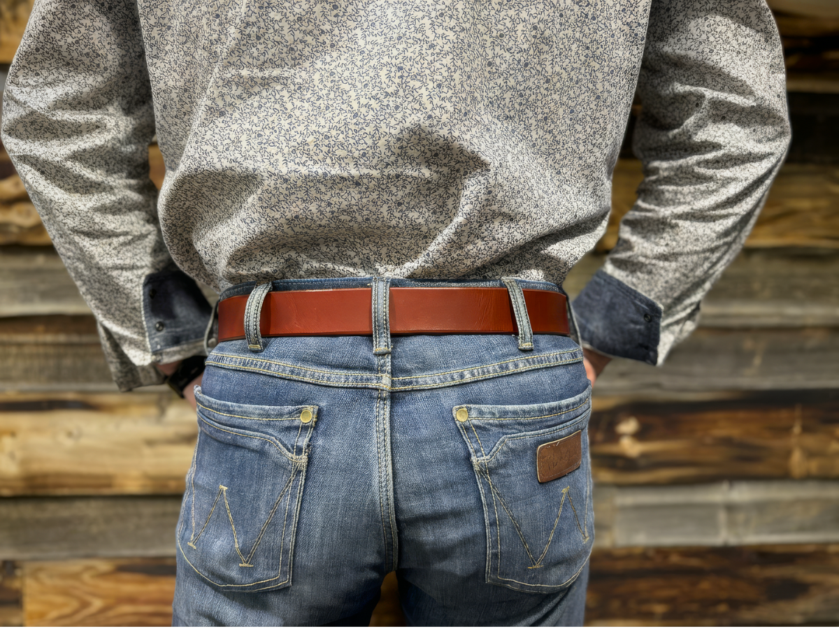 Side view of chestnut 1.5 inch leather work belt on jeans — The Heritage Belt built for blue collar men, buy once wear for life, handcrafted in Alberta - Stewart Leather