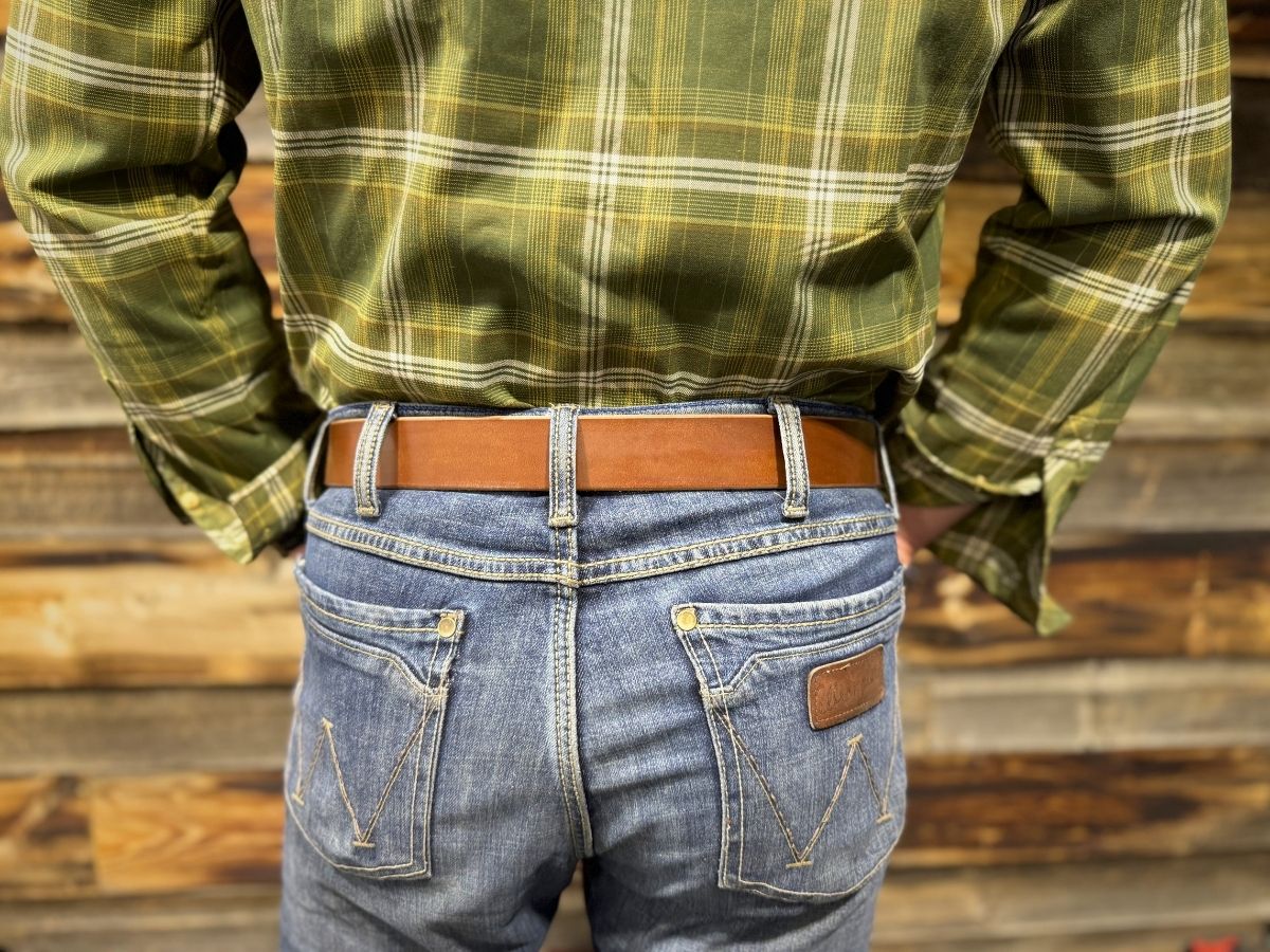Side view of rich brown 1.5 inch leather work belt on jeans — The Heritage Belt built for blue collar men, buy once wear for life, handcrafted in Alberta - Stewart Leather