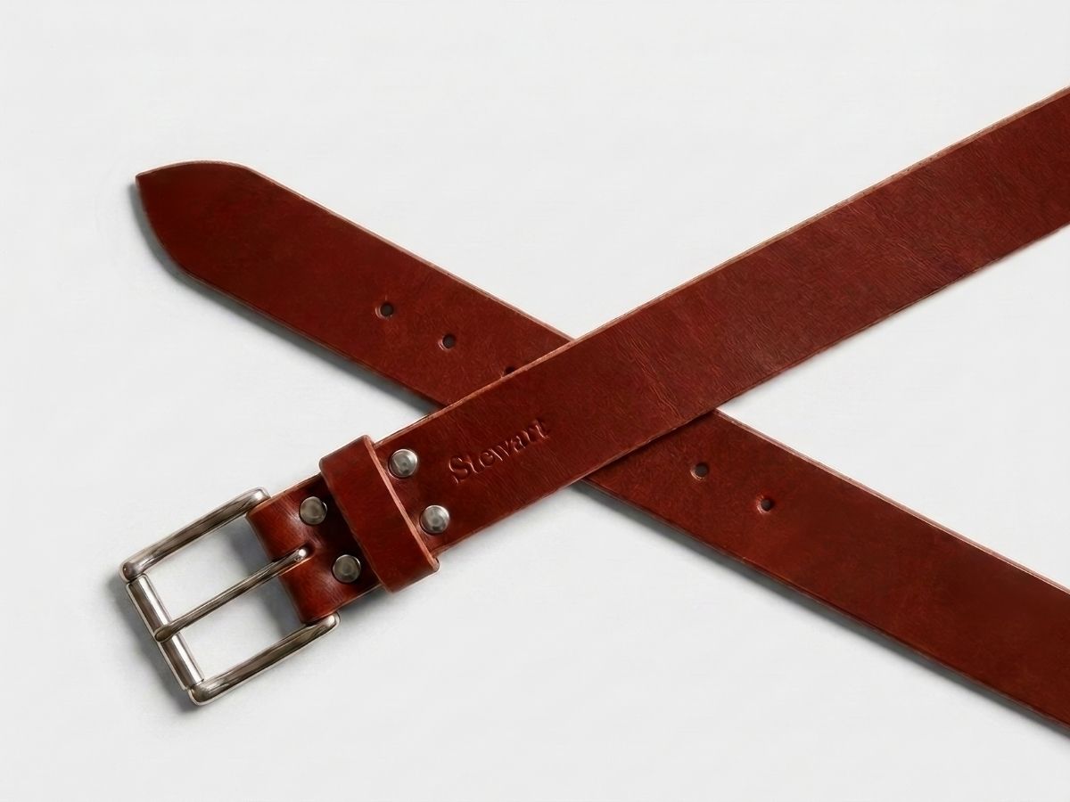 Chestnut leather work belt buckle and hardware detail — stainless steel interchangeable buckle secured with Chicago screws, made in Alberta - Stewart Leather
