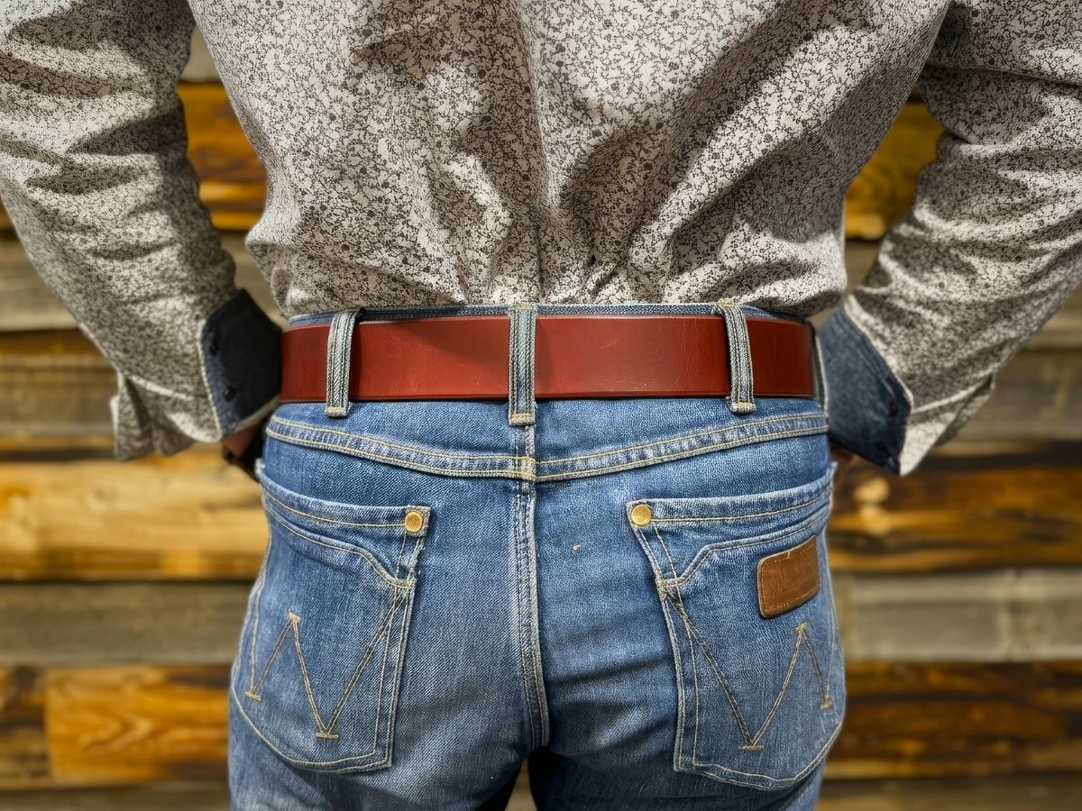 Side view of chestnut 1¾ inch leather work belt on jeans — won't twist or fold under hard work, made in Alberta for blue collar men - Stewart Leather
