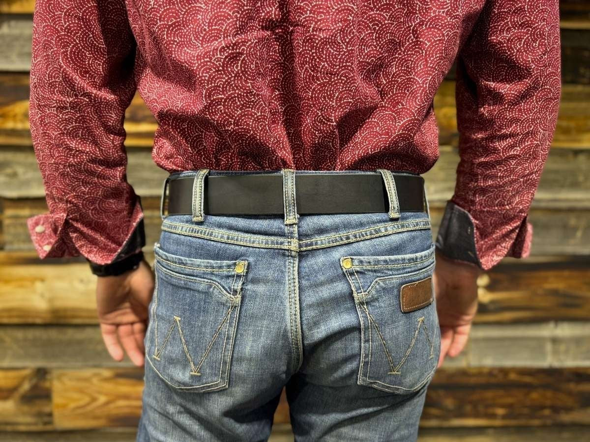 Side view of black heavy duty leather work belt on jeans — built for oilfield, trades, and farming, buy once wear for life, made in Alberta Canada - Stewart Leather