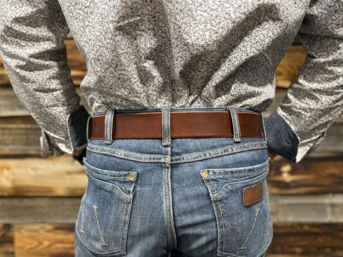 Side view of rich brown heavy duty leather work belt on jeans — built for oilfield, trades, and farming, made in Alberta Canada - Stewart Leather