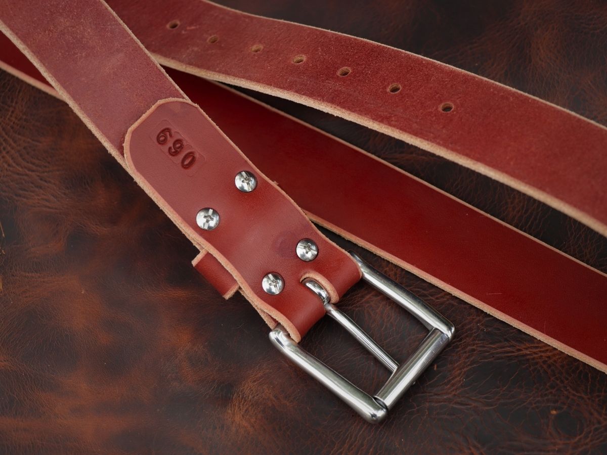 Chestnut 1.5 inch leather work belt showing beeswax burnished edges and hand-punched holes — built for daily hard wear, handcrafted in Northern Alberta - Stewart Leather